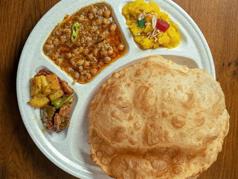 A breakfast platter with puri, channay and halwa